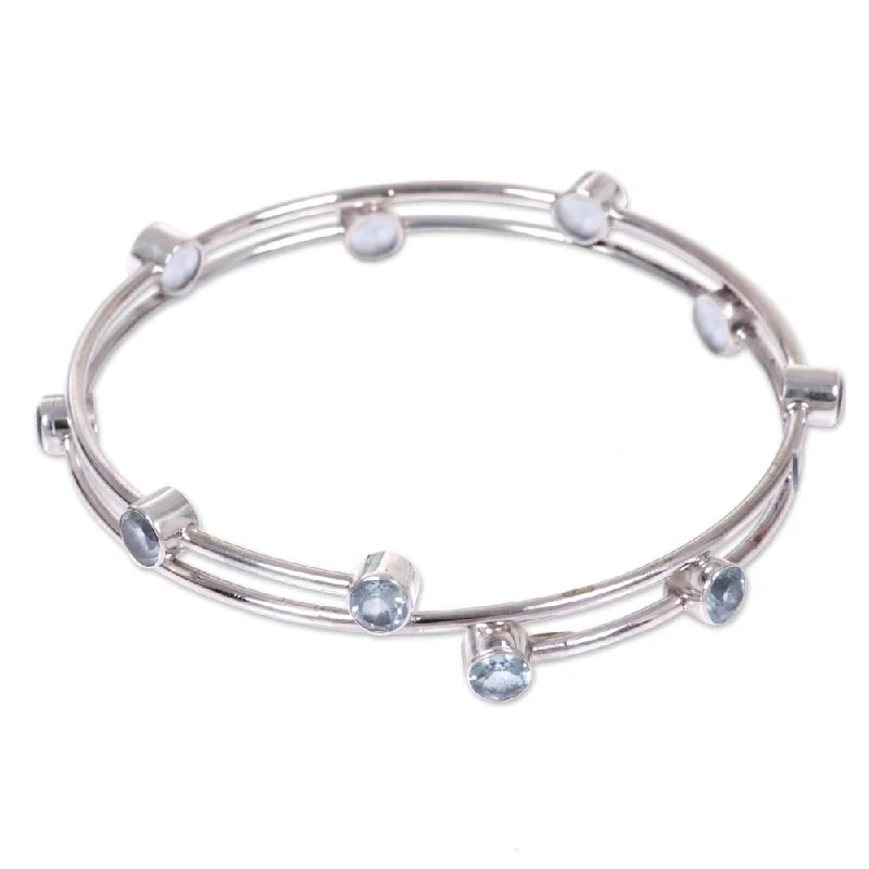 Blue Topaz Bangle Bracelet, 'Orchid Twist in Blue' (Indonesia) - 7'6" x 9'6"